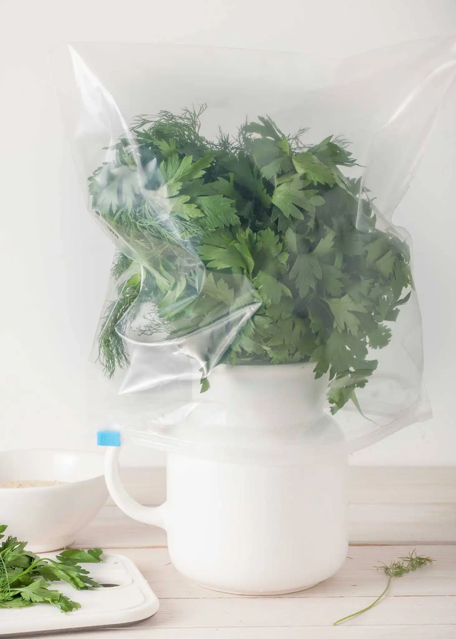 properly stored fresh herbs - in water and wrapped in plastic ba